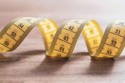 High angle view of tape measure on wooden table