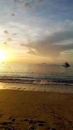 Scenic view of beach against sky during sunset