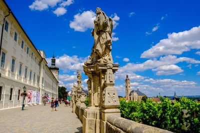 Sculptures by footpath in city