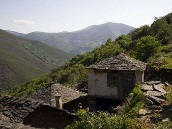 House on mountain against sky