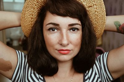 Close-up portrait of woman wearing hat