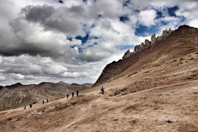 People on mountain road against sky