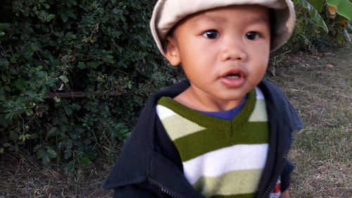 Portrait of cute boy standing outdoors