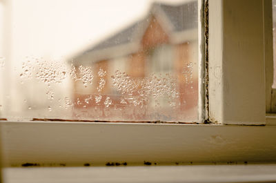 Close-up of wet glass window in rainy season