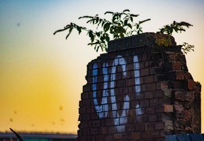 Low angle view of building against sky at sunset