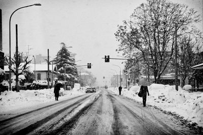 People walking on road in winter