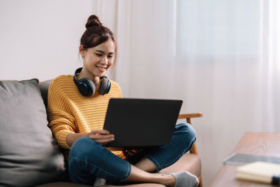 Young woman using laptop at home