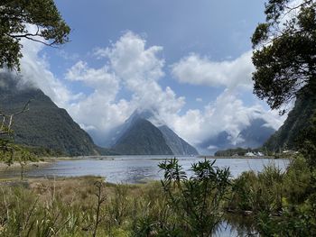 Scenic view of lake by mountains against sky