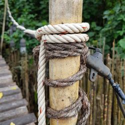 Close-up of rope tied on wooden post