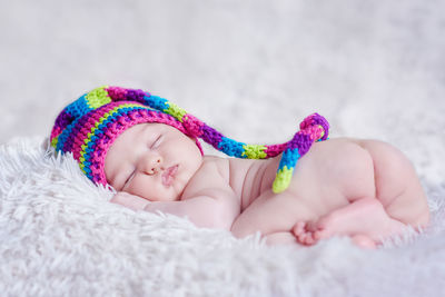 Close-up of baby sleeping on bed