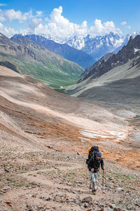 Mountaineer walks on trail