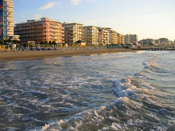 Scenic view of sea against sky in city