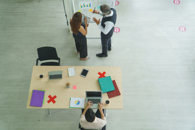 High angle view of people standing on floor