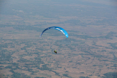 People paragliding over landscape