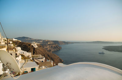 High angle view of houses on mountain by sea against sky during sunset