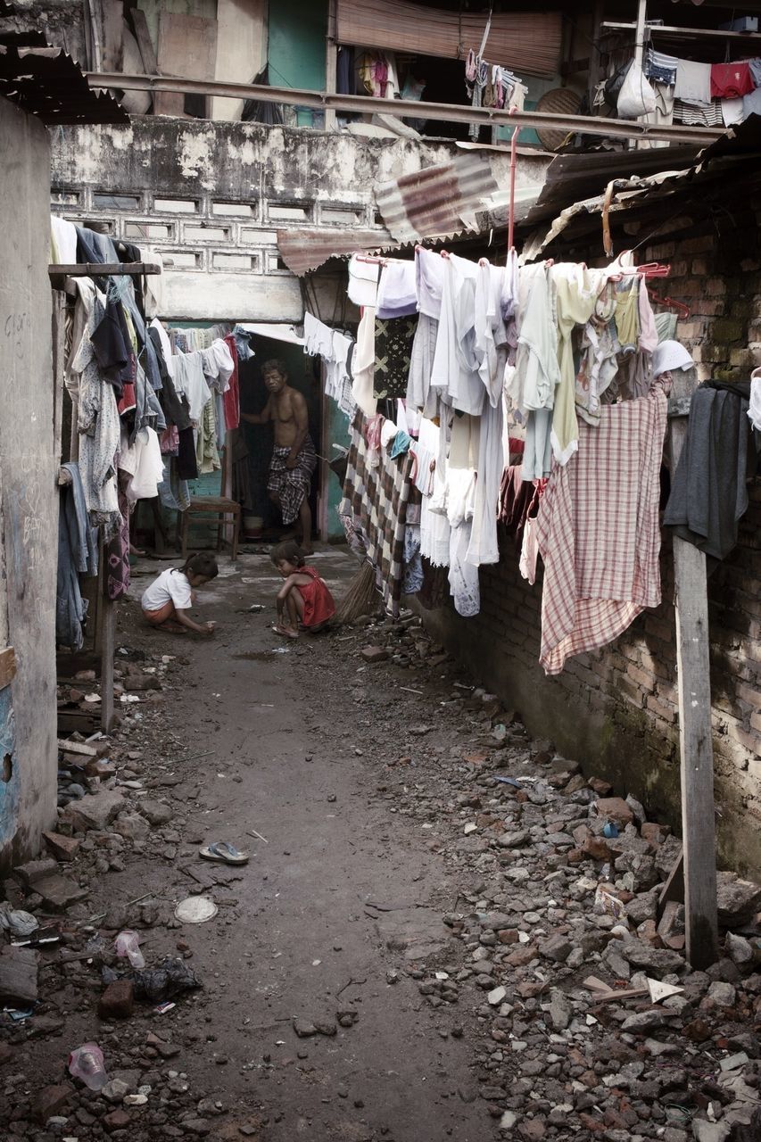 built structure, architecture, hanging, building exterior, large group of objects, abandoned, messy, day, empty, in a row, street, absence, the way forward, outdoors, wall - building feature, abundance, no people, chair, old, drying