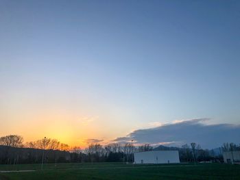 Scenic view of field against sky during sunset