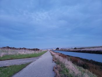 Empty road along countryside landscape