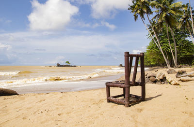 Lifeguard hut on beach against sky