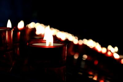 Close-up of burning tea light at night