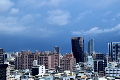 Buildings in city against sky