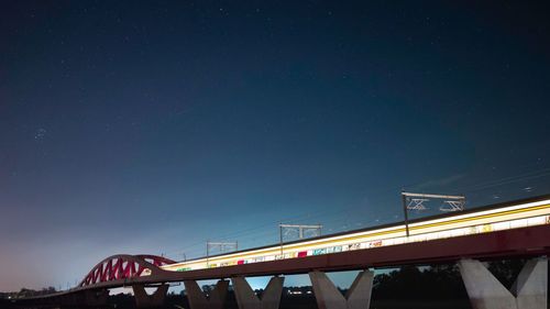 Low angle view of bridge against sky at night