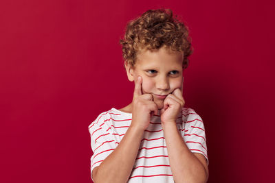 Portrait of young man with eyes closed against yellow background