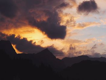 Scenic view of mountains against cloudy sky