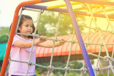 Cute girl climbing on ropes