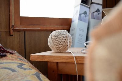 Ball of wool on table at home