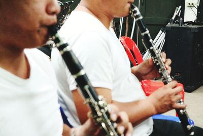 Midsection of man playing guitar