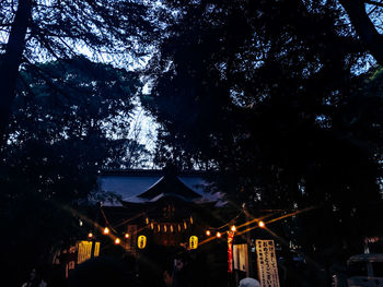 Low angle view of illuminated built structure against sky at night