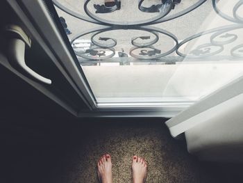 Low section of woman standing on tiled floor