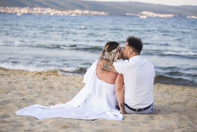 Rear view of couple on beach