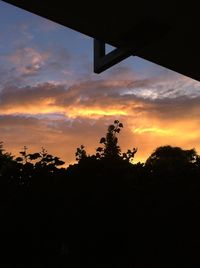 Silhouette trees against sky during sunset