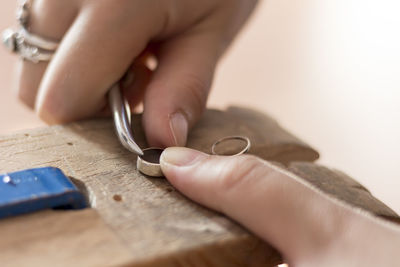 Cropped hand making ring