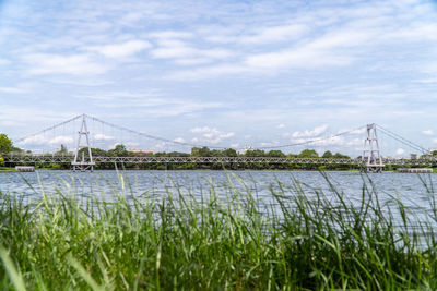 View of bridge over river against cloudy sky