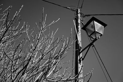 Low angle view of telephone pole against clear sky