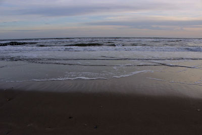 Scenic view of beach against sky during sunset