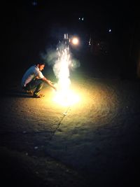 Woman playing with fire crackers at night