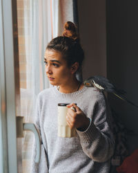 Young woman using phone at home