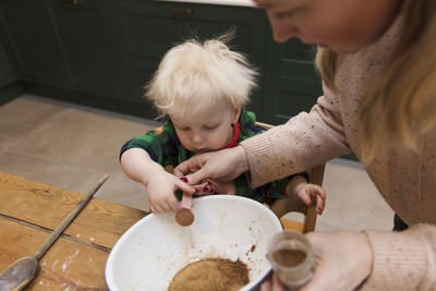 High angle view of people having food in kitchen