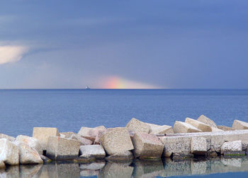 Groyne in sea against sky