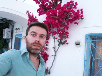 Portrait of young man against white wall
