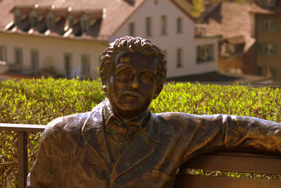 Portrait of man statue against plants