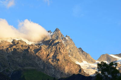 Panoramic view of mountains against blue sky