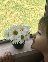 Close-up of girl and white flowering plants