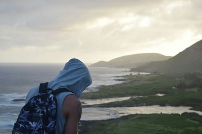 Rear view of man looking at sea