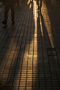 Low section of people walking on zebra crossing