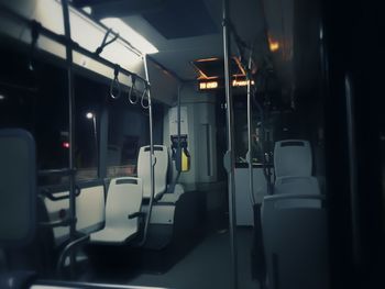 Empty chairs and tables in illuminated room